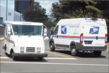  ?? Ned Gerard / Hearst Connecticu­t Media ?? Two United States Postal Service trucks at the General Post Office in New Haven on Aug. 20.