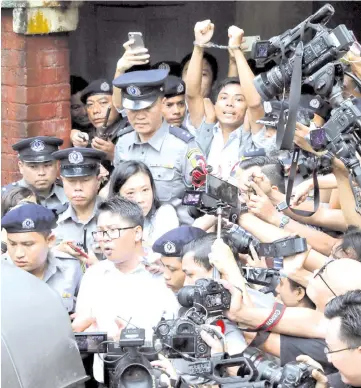  ?? — Reuters photos ?? Wa Lone (front) and Kyaw Soe Oo leave Insein court after listening to the verdict in Yangon, Myanmar.