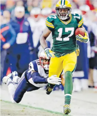  ?? Tom Lynn, The Associated Press ?? Green Bay’s Davante Adams tries to break away fromNew England’s Logan Ryan during the first half Sunday at Lambeau Field. Adams had six catches for 121 yards.