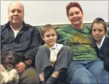  ??  ?? Kipper the cat, and her former owners – Jeff, Ben, Amanda Lewis and Sam with Mutt the dog