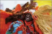  ?? AP ?? Big Chief Cantrell Watson, of the New Orleans Mardi Gras Indian tribe Wild Mohicans, chants as he parades through the New Orleans Jazz & Heritage Festival in New Orleans, on Friday.