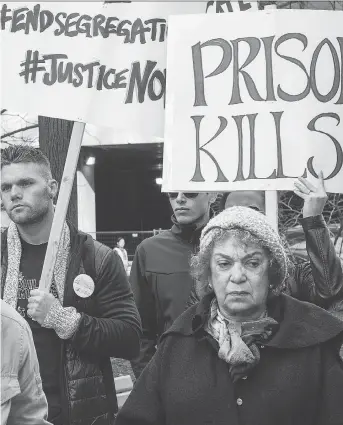  ?? WAYNE CUDDINGTON ?? Supporters listen to speakers at a protest held at the corner of Kent and Sparks Streets to voice opposition to a proposal to replace the Ottawa-Carleton Detention Centre with a new 725-bed jail.