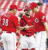  ?? JOHN MINCHILLO / ASSOCIATED PRESS ?? Reds pitcher Homer Bailey is relieved by manager Bryan Price in the third inning on Monday. Bailey lasted a season-low 2⅓ innings, setting season highs by allowing six runs and nine hits.