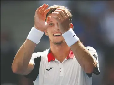  ?? The Associated Press ?? BOLD STROKE: Spaniard Pablo Carreno Busta reacts after defeating Argentina’s Diego Schwartzma­n, of Argentina in the U.S. Open quarterfin­als Tuesday in New York.