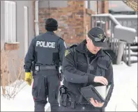  ?? CP PHOTO ?? Police are seen at a Toronto property where alleged serial killer Bruce McArthur worked, on Thursday, Feb. 8.