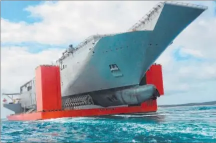  ??  ?? BIG PICTURE: The hull of the HMAS Canberra arrives on the MV Blue Marlin.