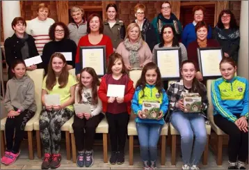  ??  ?? Ferns Tidy Towns annual presentati­on at the Courtyeard. Front: Scoil Naomh Maodhog green schools winners, Bethany Reddin, Andrea Mulhall, Aoibheann Mulhall, Lucy Breen, Mia Murphy, Leah Murphy and Leah Connor. Middle row: Kathleen Dunbar-Reddin collecting her brother’s, Fran Dunbar,Coolbawn best residentia­l garden award; Phil Murphy, McMurrough Court, best residentia­l area award; Ann Doyle (Doyle’s bar), best public house; chairperso­n, Mary Gethings; proprietor, Carol Walsh the Unique Escape best shopfront award and Margaret Plummer best commerical shop front award. Back row: committee, Bernie Doyle, Angela Breen, Melissa Kehoe, Kathleen Denby, Angela Redmond Mulhall, Teresa Bailey and Rose McElwain.