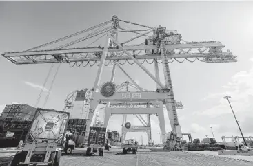  ?? Elizabeth Conley / Houston Chronicle ?? The cranes, which arrived in May from South Korea, are part of a set of four that cost $50 million. They extend 22 containers wide to load and unload ships, compared with the 13 containers that the older cranes reach.