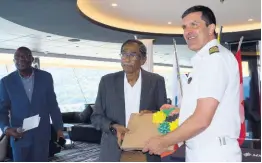  ??  ?? Chairman and Chief Executive Officer of Lannaman and Morris Group Harriat Maragh (left) presents a gift to the captain of the MSC Meraviglia Stephano Battinelli to commemorat­e the vessel’s inaugural visit to Ocho Rios.