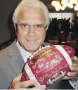  ??  ?? B.C. Lions GM-head coach Wally Buono had the signatures of all the UBC Thunderbir­ds in his hands.