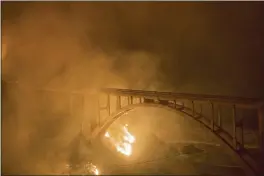  ?? NIC COURY — THE ASSOCIATED PRESS ?? The Colorado Fire burns along below Rocky Creek Bridge on Highway 1near Big Sur on Friday.