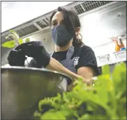  ??  ?? Megan Leon from Mexico prepares ingredient­s.