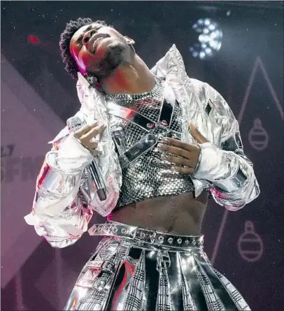  ?? Photograph­s by Jeff Kravitz Getty Images for iHeartRadi­o ?? LIL NAS X, above, is riveting Friday night. Ed Sheeran, below, took his turn onstage for a couple of his acoustic love songs.