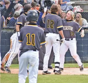  ?? STAFF PHOTO BY PATRICK MACCOON ?? Hixson’s Kane Johnson celebrates with teammates after his home run Wednesday during the District 6-AA baseball championsh­ip round. Hixson beat Signal Mountain 6-3 and 5-3 to win the title.