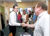  ?? NEW HAVEN REGISTER FILE PHOTO ?? Gov. Dannel Malloy shakes hands with Dan McDermott of Shelton during a visit with campaign volunteers at the Connecticu­t Democratic Party offices in New Haven in 2014.
