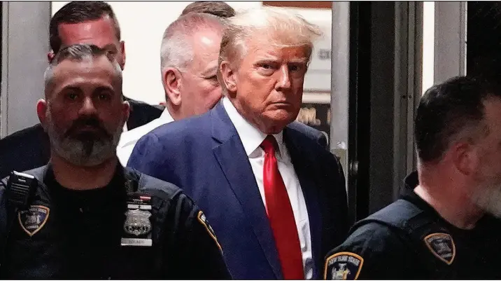  ?? MARY ALTAFFER / ASSOCIATED PRESS ?? Former President Donald Trump is escorted on April into a New York courtroom. Trump’s aggressive response to his fourth criminal indictment in five months follows a strategy he has long used against legal and political opponents: relentless attacks, often infused with language that is either overtly racist or is coded in ways that appeal to racists.