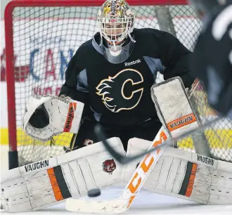  ?? JIM WELLS ?? Rookie goalie Nick Schneider, above, a workhorse with the WHL’s Calgary Hitmen last season, spent much of his time in China asking questions and learning from Flames starter Mike Smith — and delivering pizzas.