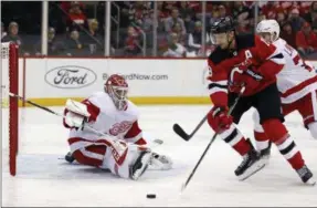  ?? ADAM HUNGER - THE ASSOCIATED PRESS ?? Detroit Red Wings goaltender Jonathan Bernier defends against New Jersey Devils center Travis Zajac during the second period of an NHL hockey game Saturday, Nov. 17, 2018, in Newark, N.J.