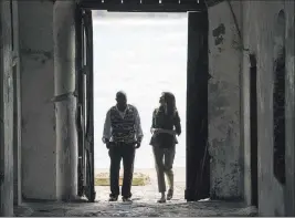  ?? Carolyn Kaster ?? The Associated Press First lady Melania Trump walks Wednesday through the “Door Of No Return” with Cape Coast Castle museum educator Kwesi Essel-blankson in Cape Coast, Ghana. Cape Coast Castle, built in the 17th century, became a slave trade outpost.