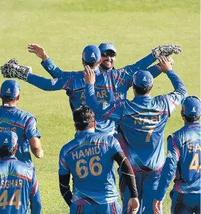  ?? PHOTO: GETTY ?? Afghanista­n players celebrate their historic World Cup win over Scotland in Dunedin last year.