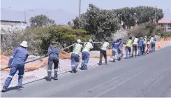  ?? SUPPLIED ?? CITY workers carry out the electrific­ation process in Jim se Bos informal settlement in Philippi. |