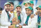  ??  ?? Pakistan captain Sarfraz Ahmed and team with the Champions Trophy after beating India in London on June 18. GETTY IMAGES