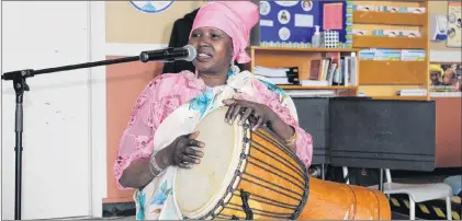  ?? SAM MCNEISH/THE TELEGRAM ?? Adut, from South Sudan, sang a traditiona­l song from her country at the Associatio­n for New Canadians Multicultu­ral Day celebratio­n at St. Pius X Church Wednesday.