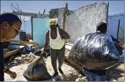  ?? RAMON ESPINOSA / ASSOCIATED PRESS ?? A woman receives donations Wednesday in front of a home destroyed by the Jan. 27 tornado on the outskirts of Havana, Cuba.