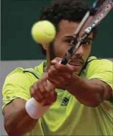  ??  ?? In this Wednesday photo France's Laurent Lokoli returns the ball to USA's Steve Johnson during their first round match of the French Open tennis tournament at the Roland Garros stadium, in Paris, France. AP PHOTO