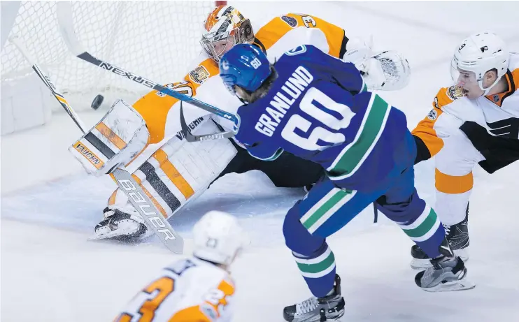  ?? — THE CANADIAN PRESS ?? Vancouver Canucks forward Markus Granlund is stopped by Philadelph­ia Flyers goalie Michal Neuvirth Sunday during the Flyers’ 3-2 win at Rogers Arena.