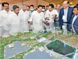  ?? BY ARRANGEMEN­T ?? Chief Minister Y.S. Jagan Mohan Reddy looks at the Integrated Renewable Energy Storage project master plan before launching the constructi­on works at Gummatam Tanda, Orvakllu mandal in Kurnool district on Tuesday.
—