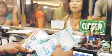  ??  ?? The ringgit will further strengthen against the US dollar this year to a fair value of between 3.80 and 3.90 to reflect Malaysia’s strong economic fundamenta­ls. — AFP photo