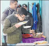  ?? ?? Jefferson Martinez smells the chipotle arroz con pollo before trying the dish as Mount Diablo High School students participat­ed in a taste test.