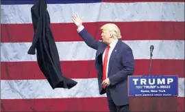  ?? Mike Groll Associated Press ?? DONALD TRUMP tosses his coat at a rally in Rome, N.Y., where for a second day he assailed a process that has cost him delegates, and maybe the nomination.