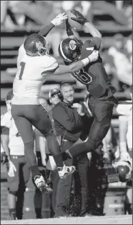  ?? Arkansas Democrat-Gazette/MELISSA SUE GERRITS ?? Ouachita Baptist wide receiver Drew White (right) snatches a pass in front of Minnesota-Duluth defensive back Darion Fletcher. White finished with 94 yards receiving and a touchdown.