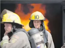  ?? RAFAL GERSZAK/FOR POSTMEDIA NEWS ?? Camp Ignite participan­ts, seen about to enter a smoking building, learn the basics of firefighti­ng.