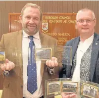  ??  ?? Simon Baston from Loft Co and Steve Price from Oriel Architects with the five building excellence awards they won between them