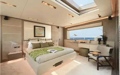  ??  ?? left: The full-beam master stateroom is located on the main deck, which allows for a skylight, making the room even brighter. below left: The tender garage doubles as a teak beach for owners and guests, with a buffet and a day head.