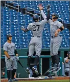  ?? Associated Press ?? Going yard: New York Yankees' Giancarlo Stanton (27) jumps to celebrate his two-run homer with Aaron Judge during the first inning of an opening day baseball game against the Washington Nationals at Nationals Park Thursday in Washington.