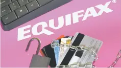  ??  ?? Credit cards, a chain and an open padlock is seen in front of displayed Equifax logo in this illustrati­on taken Sept 8. — Reuters photo