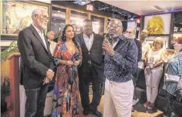  ?? PEDRO PORTAL pportal@miamiheral­d.com ?? Jimmy Moise, far right, founder of the Le P’ti Club, introduces, from left, Haitian artists Philippe Dodard, Claudia Apaid and Jean-Jacques Stephen during the 2022 Caribbean Fine Art Exhibit and Awards reception.