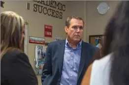  ?? Gilbert Bernal/The Signal ?? State Sen. Scott Wilk listens during his visit Wednesday to Golden Valley High School’s PAWS Center, where he met with the PAWS Center team, including resource coordinato­r April Rego, left, and school social worker Cindy Takamoto.