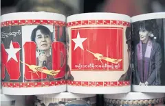  ??  ?? Coffee mugs featuring Aung San Suu Kyi are on sale at the National League for Democracy headquarte­rs in Yangon.