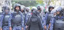  ??  ?? MOHAMED SHARUHAAN/AP A Maldivian opposition supporter stands facing police during a protest demanding the release of political prisoners in Male, Maldives, on Feb. 2, 2018.