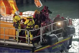  ?? GARETH FULLER — PA VIA AP ?? A group of people thought to be migrants are brought into Dover, England, by the RNLI, following a small boat incident in the English Channel on Thursday.
