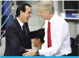  ??  ?? PARIS: File photo shows, Paris Saint-Germain’s Spanish head coach Unai Emery (L) shakes hands with Arsenal’s French manager Arsene Wenger during the UEFA Champions League Group A football match between Paris-Saint-Germain and Arsenal in Paris. Unai...