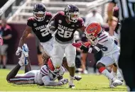  ??  ?? A&M’s Isaiah Spiller, who rambled for 174 yards and two scores, says, “I feel like we gained our identity today.”