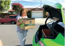  ?? AP PHOTO BY RYAN NAKASHIMA ?? Customer Maureen Blaskovich pulls her groceries out of the trunk of a self-driving Lincoln MKZ outfitted with technology by AutoX, in San Jose, Calif., last week.