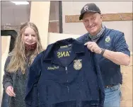  ??  ?? PRHS FFA student Mallory Pruitt receives her jacket from teacher Perry Mason.