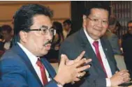  ??  ?? Johari (left) stressing a point during a luncheon in conjunctio­n with the 21st Malaysian Capital Market Summit yesterday. Listening attentivel­y is ASLI CEO Tan Sri Michael Yeoh.